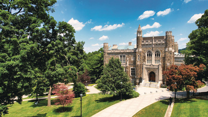 Exterior view of Linderman Library at Lehigh University, framed by trees on a sunny day.